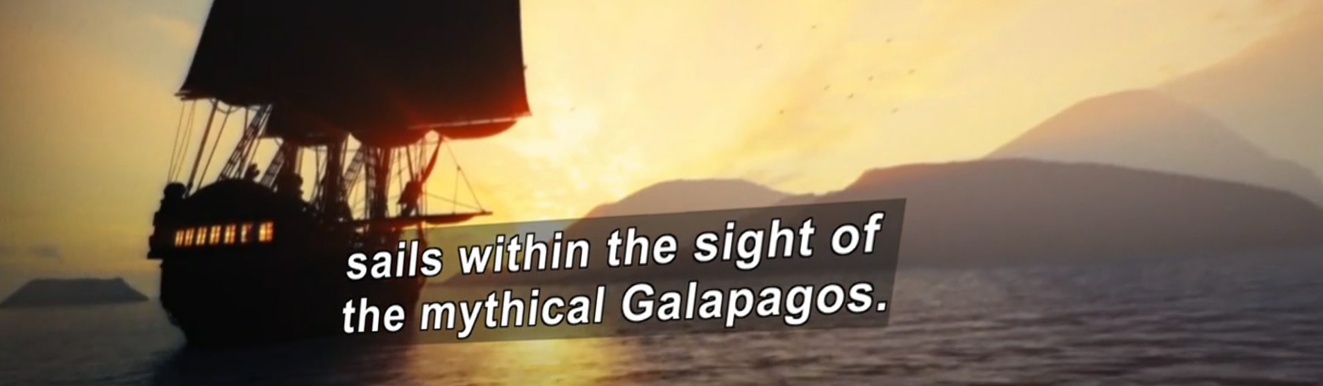 A ship with sails is silhouetted against a warm sunset. Screen shot from a video with captions.