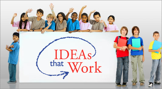 Several children hold a large sign that says Ideas that Work.