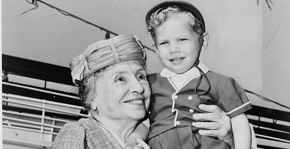 Helen hoists a young boy on her shoulder