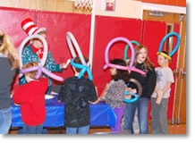 children wear balloon hats in a gymnasium